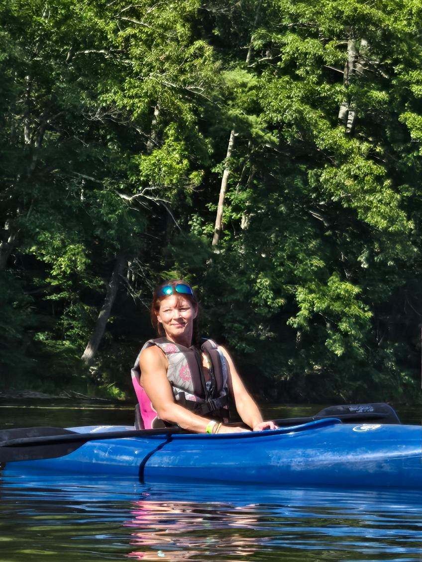Community member kayaking on the water — wellness and recreation programming